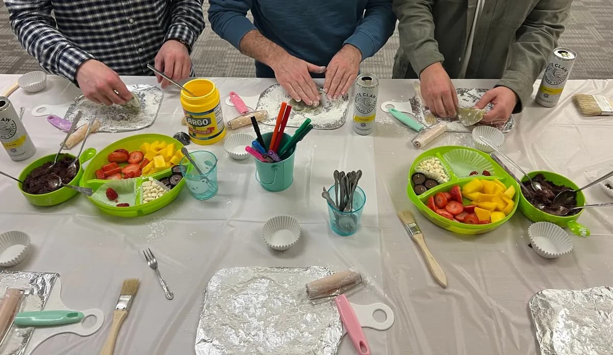 Hands shaping mochi with fruit and other fillings